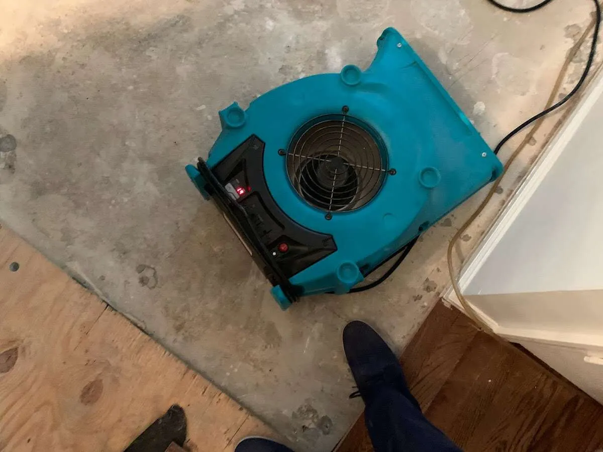 Air mover drying subfloor during Leak Detection & Repair in Triangle